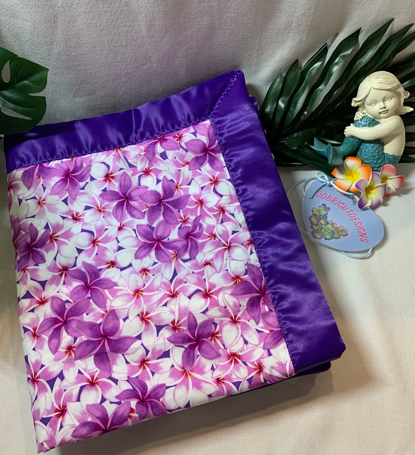 100% Cotton plumeria print with white Minky and satin trim baby blanket