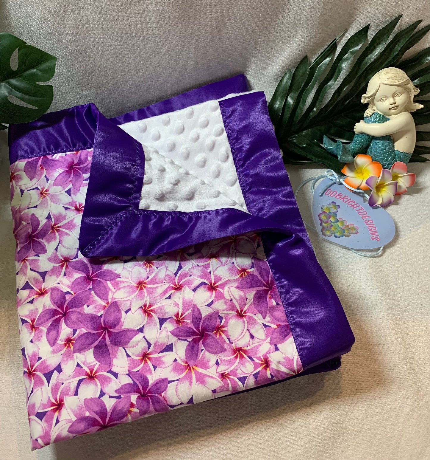 100% Cotton plumeria print with white Minky and satin trim baby blanket
