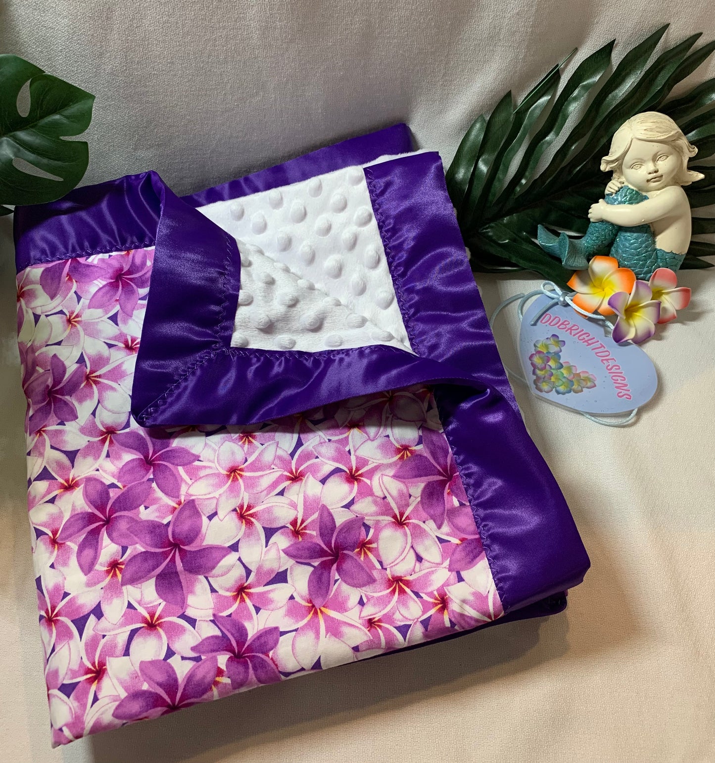 100% Cotton  plumeria print with white Minky and satin trim baby blanket