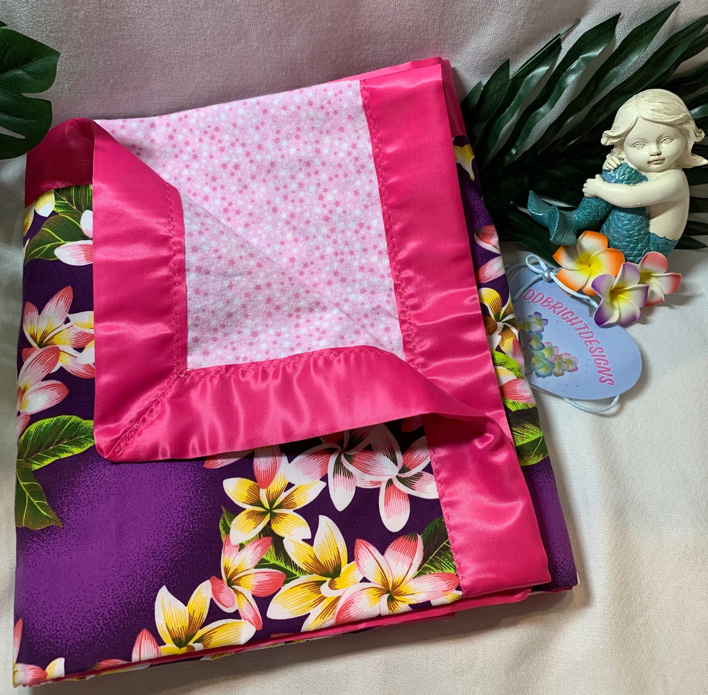 100% cotton Aloha print purple and bubble gum pink satin trim baby blanket